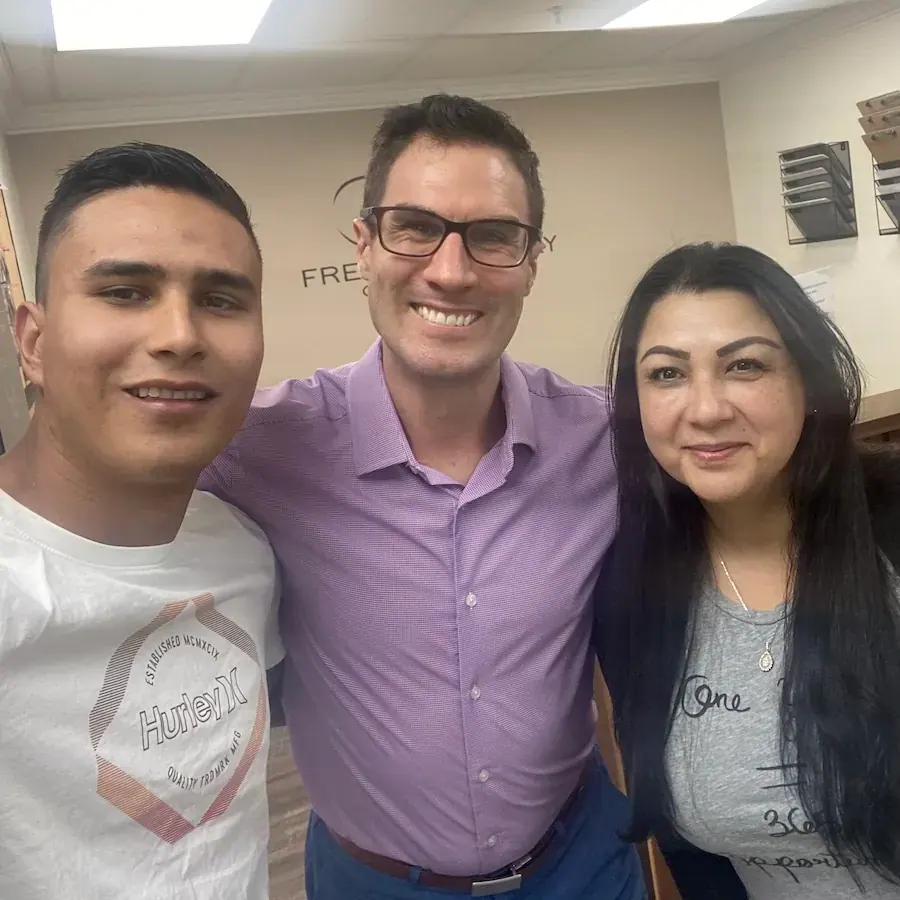 Patients posing with Dr. David Ridos