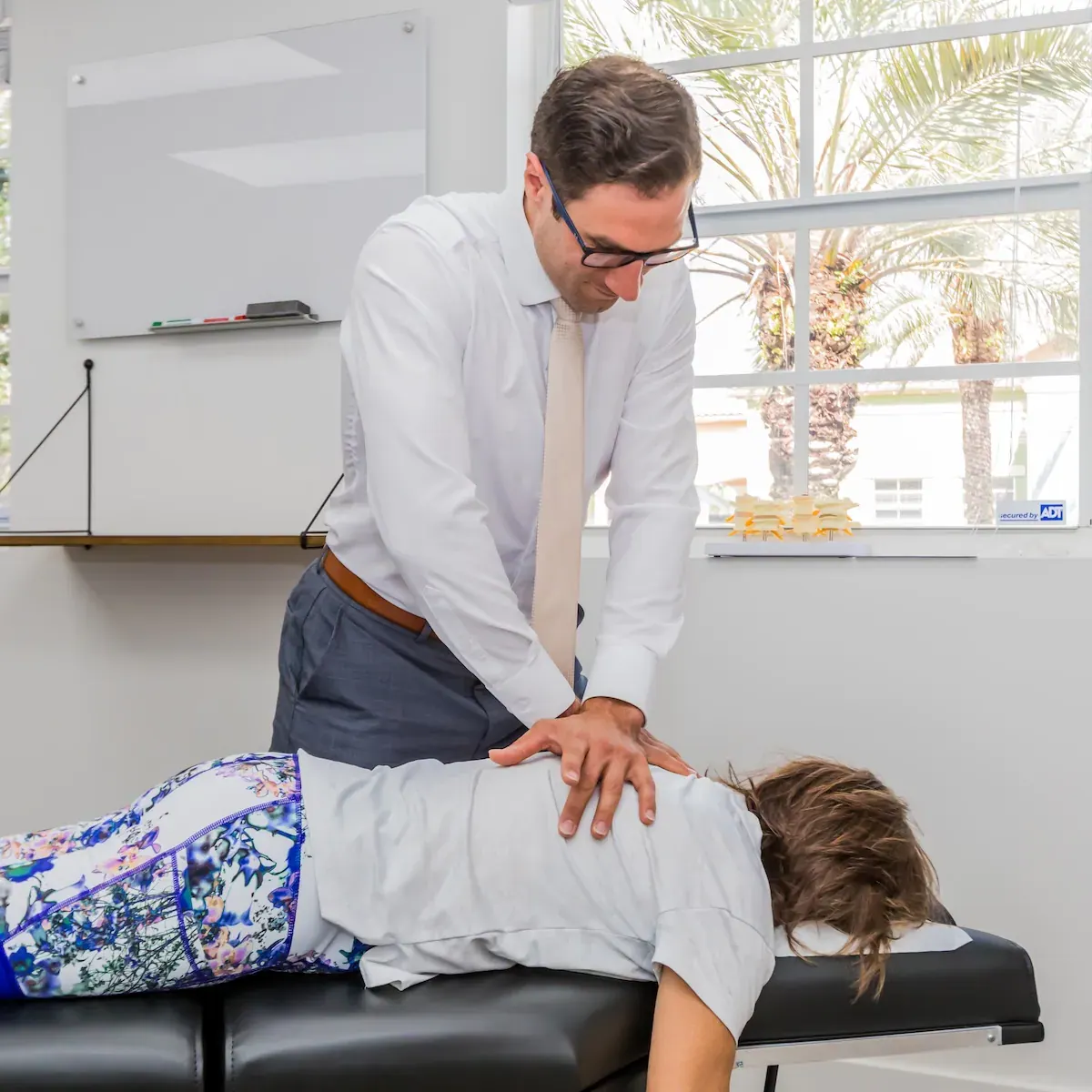 Dr. David Ridos adjusting a patient's back