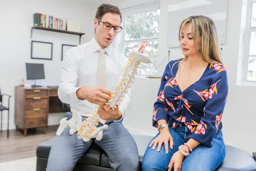 Dr. David Ridos explaining a spine model to a patient