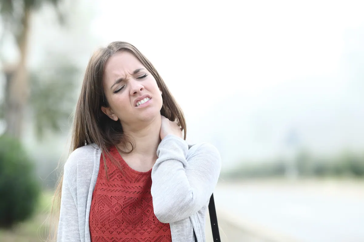 Woman holding her neck in pain