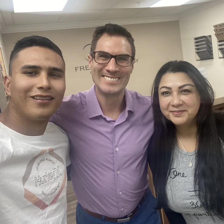 Patients posing with Dr. David Ridos