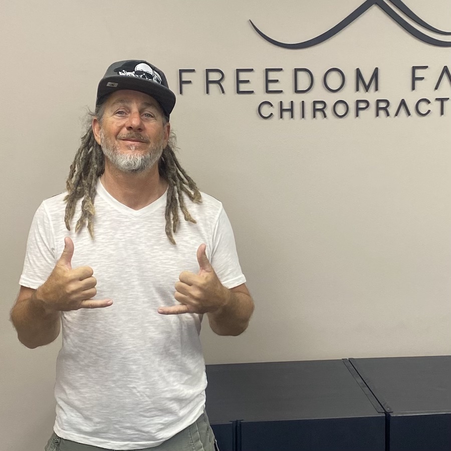Patient standing in chiropractic office
